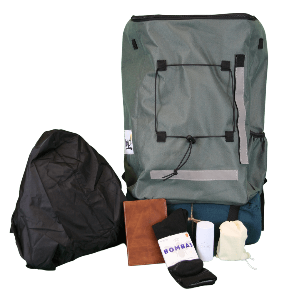 Hito Pak with all contents spread out including Bombas socks, deodorant, and poncho